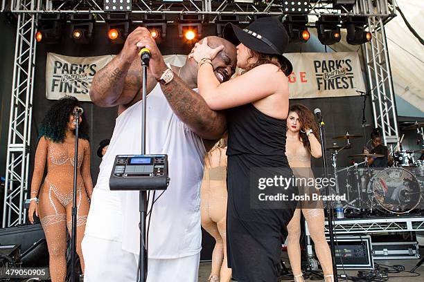 Cee Lo Green receives a kiss from Rachael Ray during his performance on stage at Rachael Ray's 7th annual Feedback Party at Stubbs on March 15, 2014...