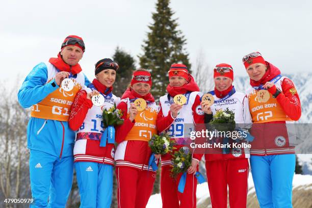 Silver medalist Mikhalina Lysova of Russia and guide Alexey Ivanov, gold medalist Elena Remizova of Russia and guide Natalia Yakimova and bronze...