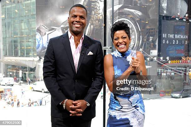 Calloway interviews Tamron Hall during her visit to "Extra" at their New York studios at H&M in Times Square on June 30, 2015 in New York City.