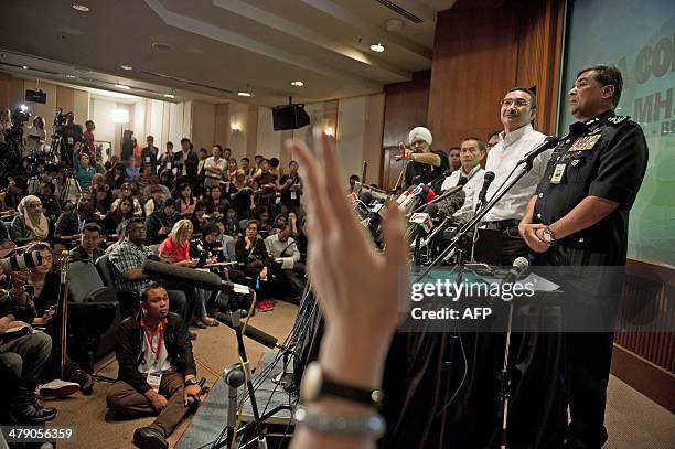 Journalist raises her hand as Malaysia's Minister of Defence and Acting Transport Minister Hishammuddin Hussein answers questions during a press...