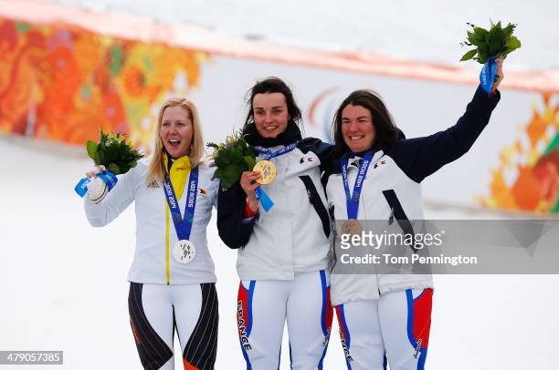 Gold medalist Marie Bochet of France celebrates with silver medalist Andrea Rothfuss of Germany and bronze medalist Solene Jambaque of France during...