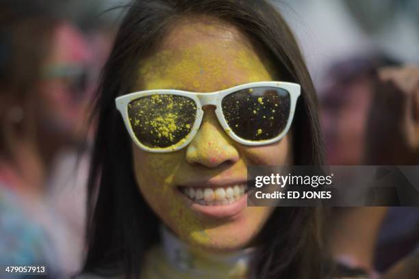 Reveller poses for a photo as she takes part in Holi celebrations organised by members of South Korea's Indian community at Haeundae beach in the...