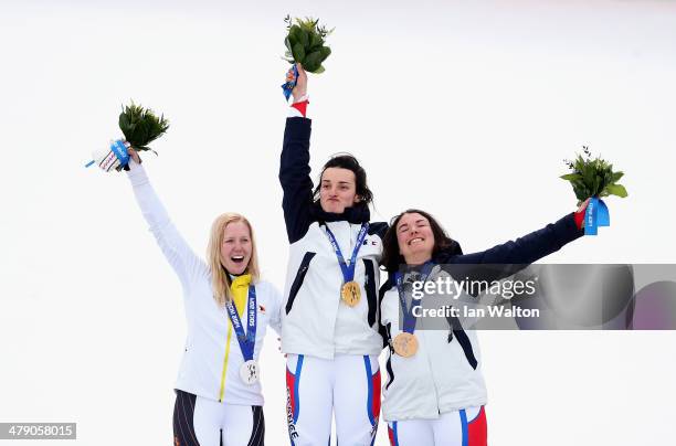 Gold medalist Marie Bochet of France celebrates with silver medalist Andrea Rothfuss of Germany and bronze medalist Solene Jambaque of France during...