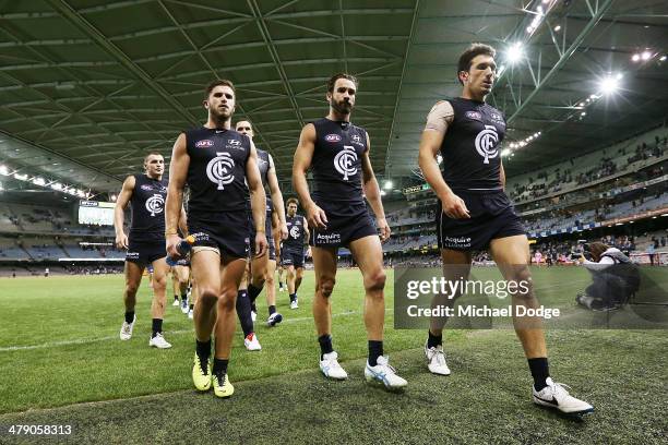 Marc Murphy Andew Walker and Michael Jamison of the Blues walk off after their defeat during the round one AFL match between the Carlton Blues v Port...