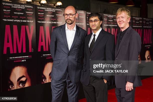 British producer James Gay-Rees, British director Asif Kapadia and editor Chris King pose on the red carpet at the premiere of the film Amy in...