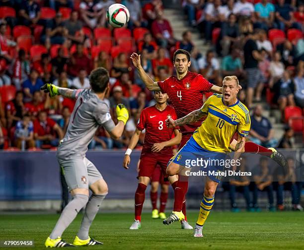 Paulo Oliveira and Jose Sa of Portugal battle for the ball with John Guidetti of Sweden during UEFA U21 European Championship final match between...