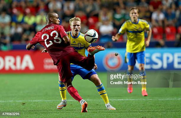 Oscar Hiljemark of Sweden and Joao Mario of Portugal battle for the ball during the UEFA European Under-21 final match between Sweden and Portugal at...