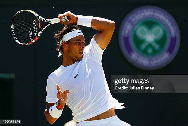 Rafael Nadal of Spain in action in his Gentlemens Singles first round match against Thomaz Bellucci of Brazil during day two of the Wimbledon Lawn...