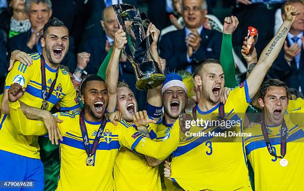 Oscar Hiljemark lifts up trophy with John Guidetti and team-mates after Swedish victory in UEFA U21 European Championship final match between...