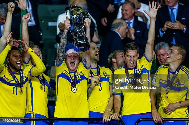 John Guidetti lifts up trophy after Swedish victory in UEFA U21 European Championship final match between Portugal and Sweden at Eden Stadium on June...