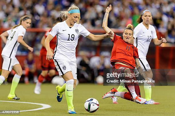 Julie Johnston of the United States moves the ball against Anja Mittag of Germany in the first half in the FIFA Women's World Cup 2015 Semi-Final...