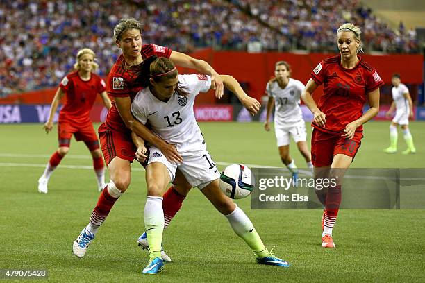 Alex Morgan of the United States with the ball against Simone Laudehr, Annike Krahn and Lena Goessling of Germany in the first half in the FIFA...