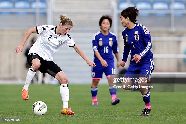 Bianca Schmidt of Germany challenges Kozue Ando of Japan in action during the Algarve Cup final match between Germany and Japan on March 12, 2014 in...