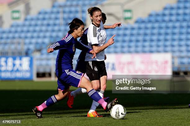 Bianca Schmidt of Germany challenges Kozue Ando of Japan in action during the Algarve Cup final match between Germany and Japan on March 12, 2014 in...