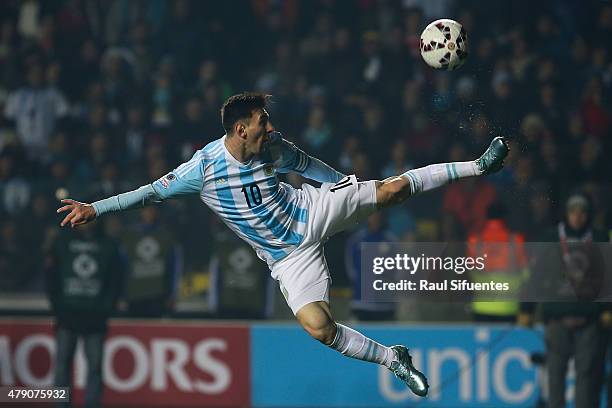 Lionel Messi of Argentina jumps to control the ball during the 2015 Copa America Chile Semi Final match between Argentina and Paraguay at Ester Roa...