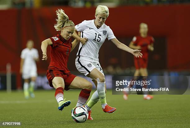 Megan Rapinoe of USA is tackled by Leonie Maier of Germany during the FIFA Women's World Cup 2015 semi final match between USA and Germany at Olympic...
