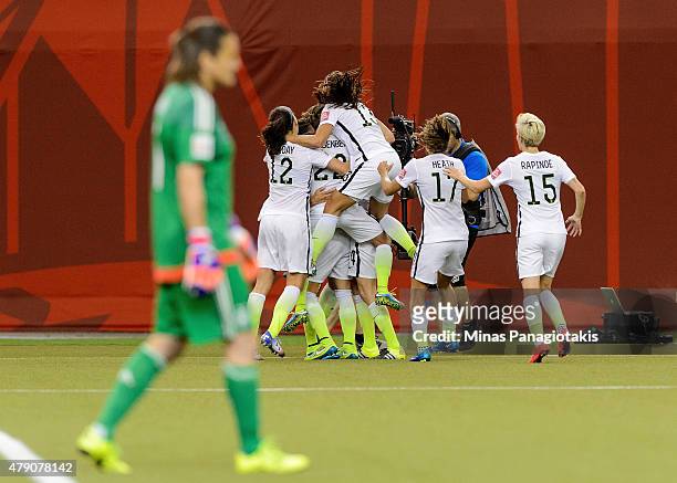 Carli Lloyd of the United States celebrates with teammates after scoring on a penalty kick for the opening goal against Germany in the FIFA Women's...