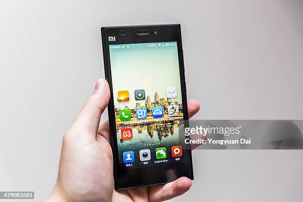using a xiaomi smartphone - xiaomi stock pictures, royalty-free photos & images
