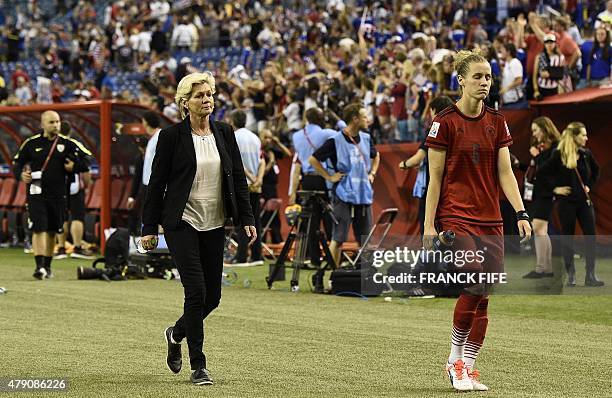 Germany's head coach Silvia Neid and Germany's midfielder Simone Laudehr leave a field during the semi-final football match between USA and Germany...