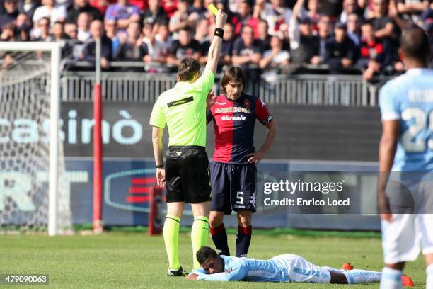 The referee shows the yellow card to Daniele Conti of Cagliari during the Serie A match between Cagliari Calcio and SS Lazio at Stadio Sant'Elia on...