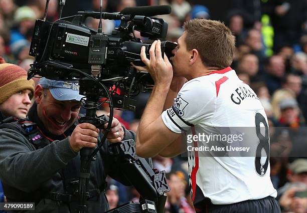 Steven Gerrard of Liverpool celebrates scoring the second goal by kissing the steadicam during the Barclays Premier League match between Manchester...