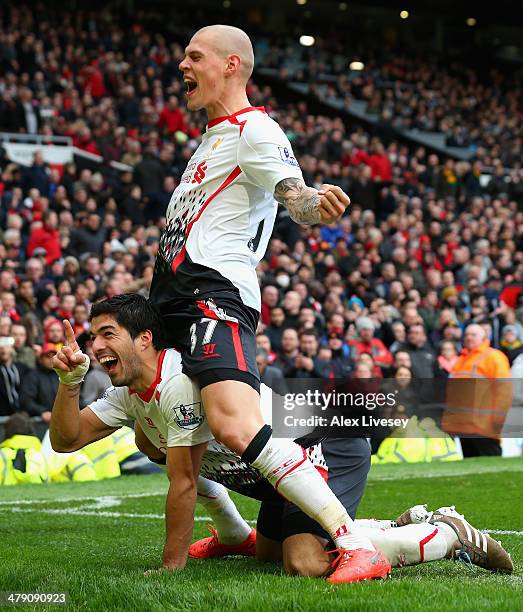 Luis Suarez of Liverpool celebrates scoring his team's third goal with Martin Skrtel during the Barclays Premier League match between Manchester...