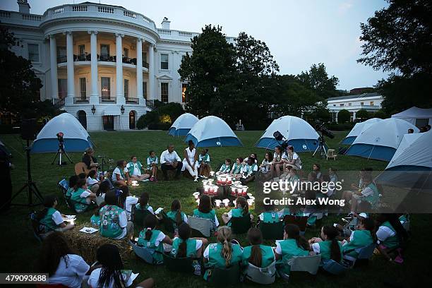 President Barack Obama and first lady Michelle Obama participate in a campfire songs session with fourth-grade Girl Scouts during the first-ever...