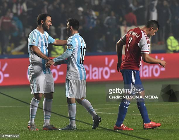 Argentina's forward Gonzalo Higuain celebrates with Argentina's forward Lionel Messi after scoring against Paraguay during their Copa America...