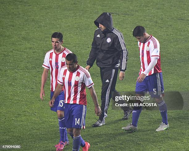 Paraguayan players leave in dejection after their Copa America semifinal football match against Argentina in Concepcion, Chile on June 30, 2015....