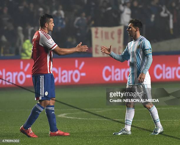 Argentina's forward Lionel Messi and Paraguay's forward Raul Bobadilla shakes hands at the end of their Copa America semifinal football match in...