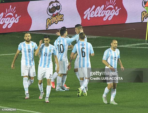 Argentina's defender Marcos Rojo celebrates with teammates after scoring against Paraguay during their Copa America semifinal football match in...