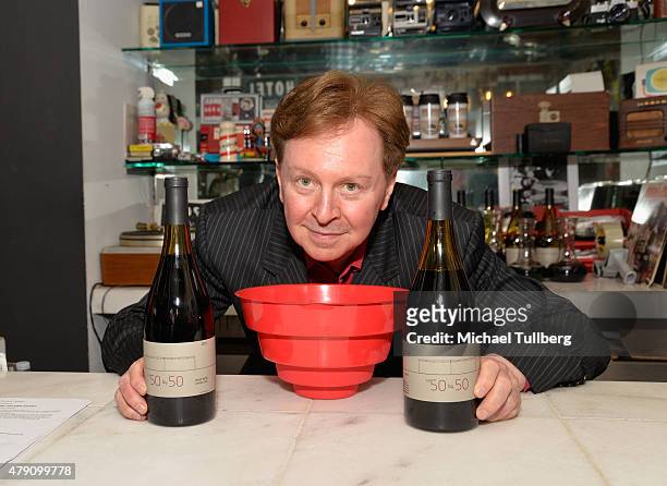 Musician and winemaker Gerald Casale of DEVO poses with bottles of his The 50 By 50 wine brand at a wine tasting at The Record Parlour on June 30,...