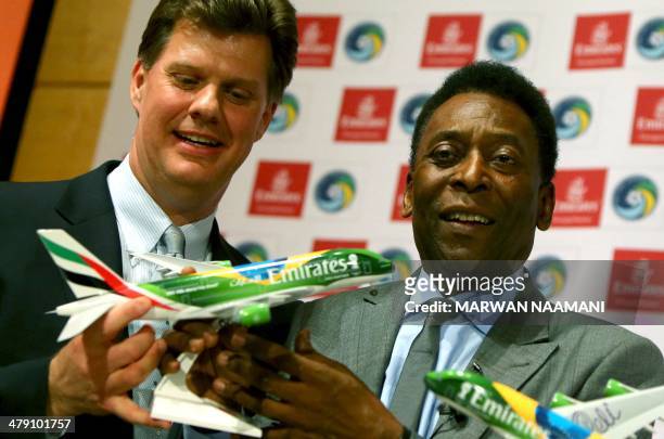 Soccer legend Pele and Seamus O'Brien Chairman of New York Cosmos soccer club pose with a model of Emirates plane sporting the colors of Brazilan...