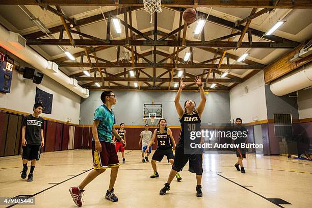 High school girls play against middle school boys in a game of basketball on June 29, 2015 in Newtok, Alaska. Newtok, which has a population of...