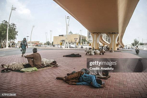 Pakistani people rest under a bridge during a heatwave in Karachi, Pakistan, July 01, 2015. Nearly two-thirds of the victims of a killer heatwave...