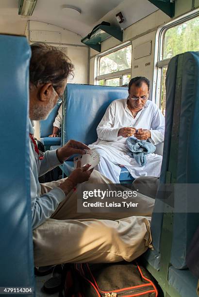 Men pass the time with a card game on the 1898 built Kalka Shimla Railway, a narrow gauge railway in North-West India that travels between the...