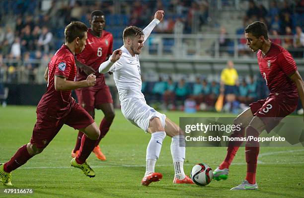 Carl Jenkinson of England with Raphael Guerreiro and Tiago Ilori of Portugal during the UEFA Under21 European Championship 2015 Group B match between...