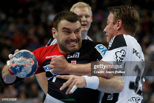 Bartosz Jurecki of Magedeburg is challenged by Filip Jicha of Kiel during the Bundesliga handball match between THW Kiel and SC Magdeburg at the...