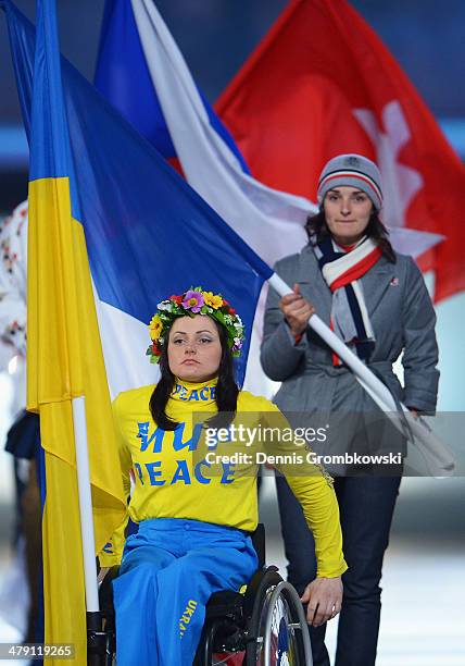 Flagbearer and Cross Country skier Lyudmyla Pavlenko of Ukraine enters the stadium during the Sochi 2014 Paralympic Winter Games Closing Ceremony at...