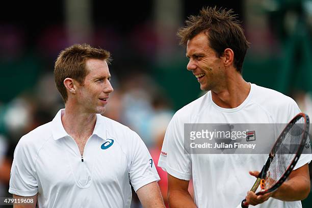 Frederik Nielsen of Denmark and Jonathan Marray of Great Britain talk tactics in their Gentlesmens Doubles First Round match against Fabrice Martin...