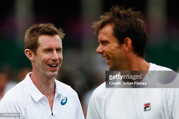 Frederik Nielsen of Denmark and Jonathan Marray of Great Britain talk tactics in their Gentlesmens Doubles First Round match against Fabrice Martin...