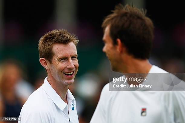 Frederik Nielsen of Denmark and Jonathan Marray of Great Britain talk tactics in their Gentlesmens Doubles First Round match against Fabrice Martin...