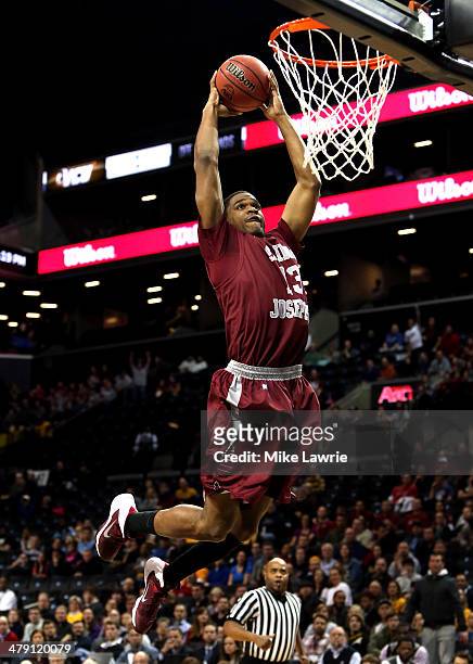 Ronald Roberts, Jr. #13 of the Saint Joseph's Hawks goes up for a dunk in the first half against the Virginia Commonwealth Rams during the...