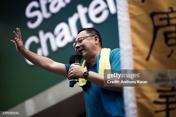 Benny Tai chants on a street during a pro-democracy march on July 1, 2015 in Hong Kong. July 1 is traditionally a day of protest in Hong Kong and...
