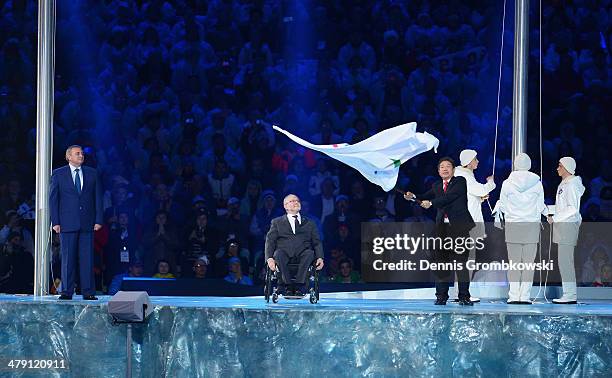 Mayor of Pyeongchang Lee Seok-rae waves the Paralympic flag watched by International Paralympic Committee President Sir Philip Craven and Mayor of...