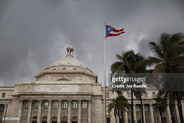 The Puerto Rican flag flies near the Capitol building as the island's residents deal with the government's $72 billion debt on July 1, 2015 in San...