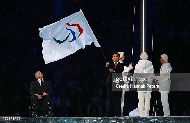 Mayor of Pyeongchang Lee Seok-rae waves the Paralympic flag watched by International Paralympic Committee President Sir Philip Craven during the...