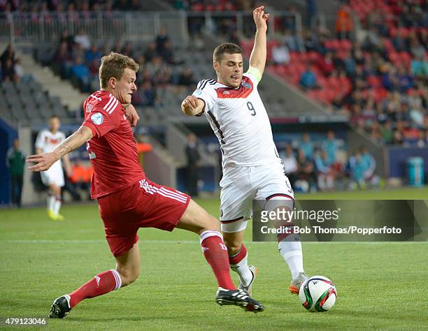 Kevin Volland of Germany is tackled by Alexander Scholz of Denmark during the UEFA European Under-21 Group A match between Germany and Denmark at...