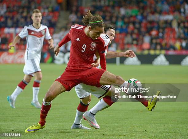 Yussuf Poulsen of Denmark is tackled by Nico Schulz of Germany during the UEFA European Under-21 Group A match between Germany and Denmark at Eden...