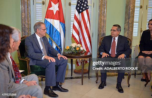 The head of US Interest Section, Jeffrey DeLaurentis , talks with Cuban Foreign Vice-Minister Marcelino Medina, before giving him a letter from US...